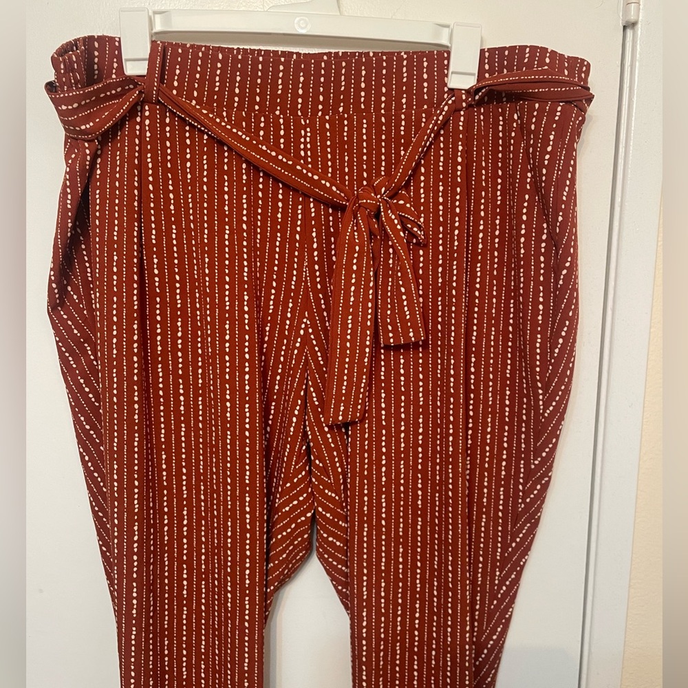 Rustic orange pants with white design/print.